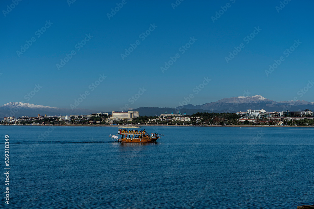 boat in the blue sea near the city