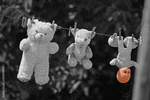 Plush children's toys hang on the wire after washing photo