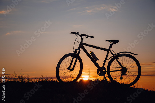 silhouette of a bicycle on the sunset sky
