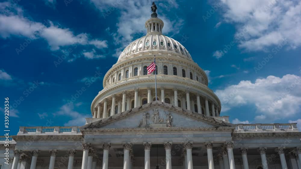 Closeup push-in time lapse cinemagraph view of the US Capitol looking up as clouds float to the right in a blue sky. Closeup push-in time lapse cinemagraph view of the US Capitol looking up as clouds float to the right in a blue sky.
