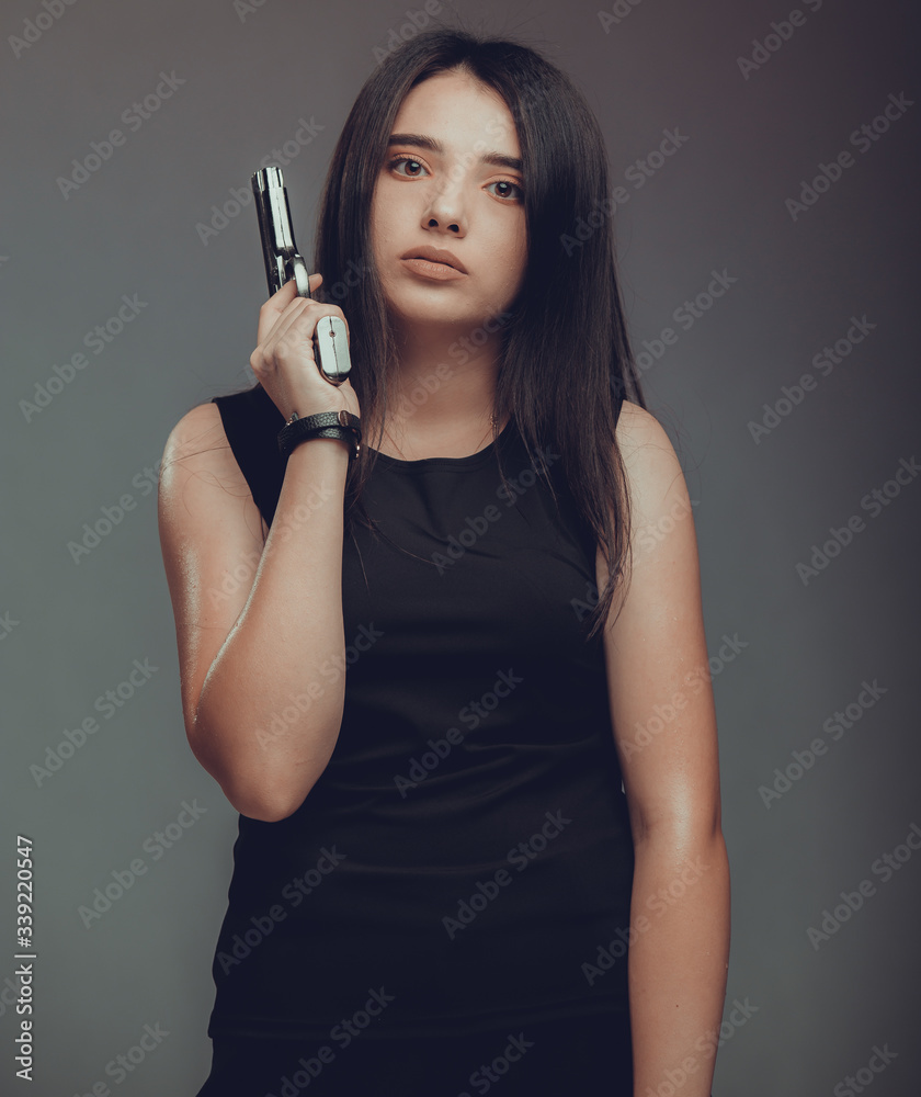 Shot of a sexy military woman posing with guns Shot of a sexy military woman posing with guns