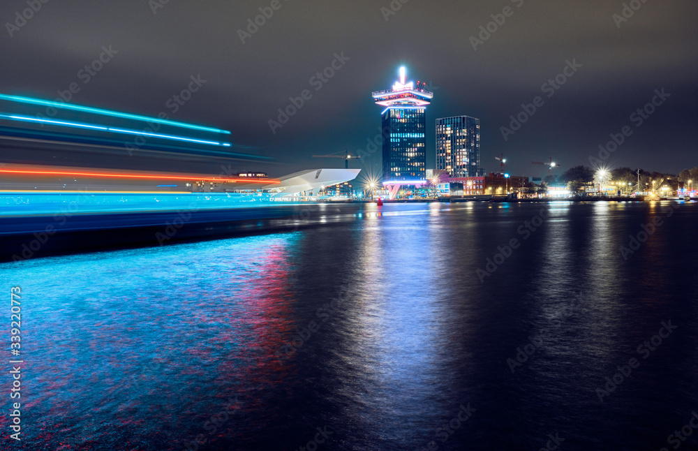 Modern architecture and ferry in motion in Amsterdam. Modern architecture and ferry in motion in Amsterdam.