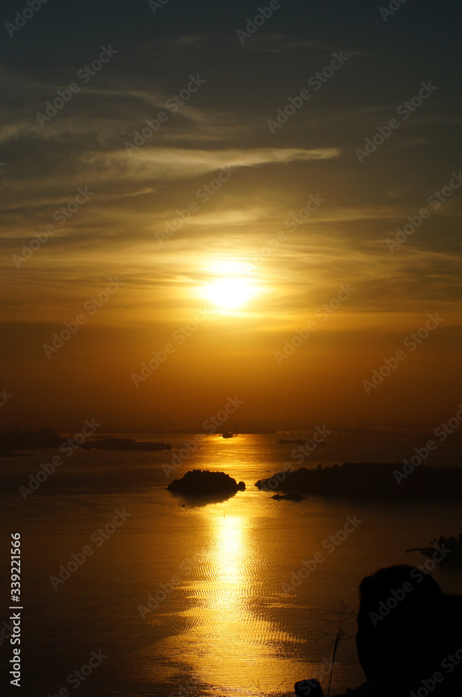 Sunset at Niteroi and Rio de Janeiro cities, Brazil. View of tourist spots in the cities, such as Guanabara Bay, Sugarloaf Cable Car, Christ the Redeemer statue