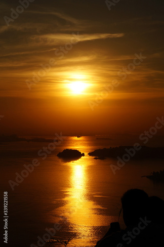 Sunset at Niteroi and Rio de Janeiro cities  Brazil. View of tourist spots in the cities  such as Guanabara Bay  Sugarloaf Cable Car  Christ the Redeemer statue