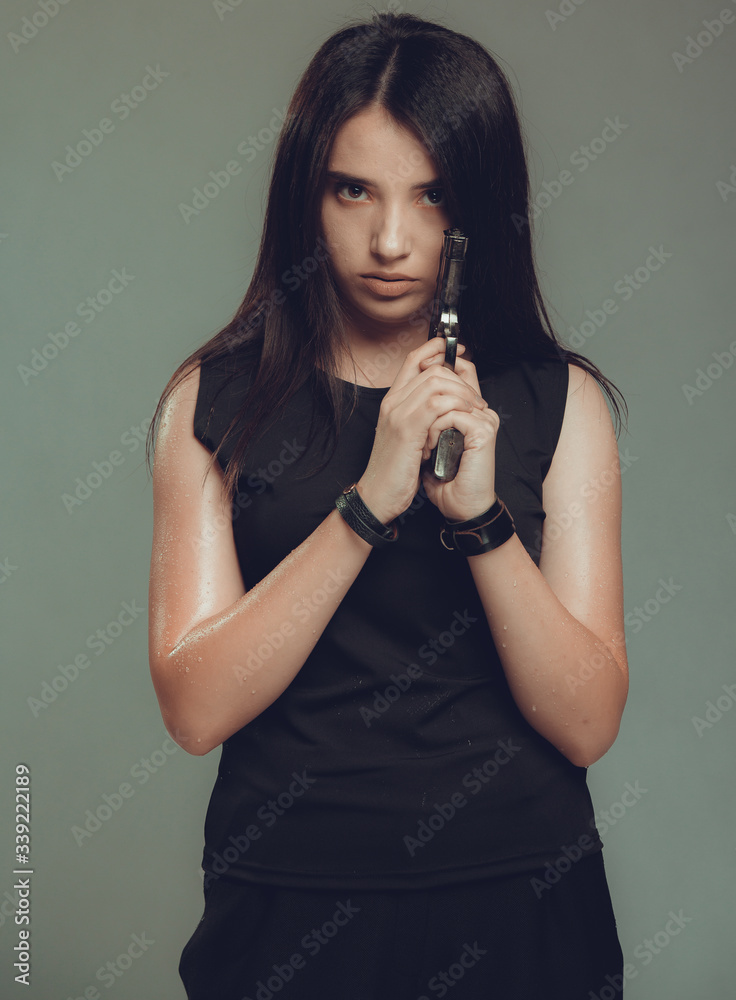 Shot of a sexy military woman posing with guns Shot of a sexy military woman posing with guns