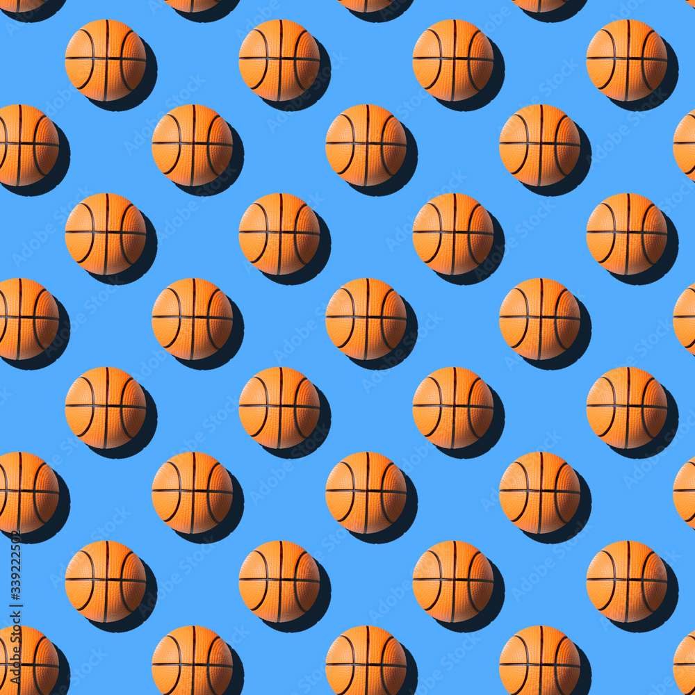 Basketball balls seamless pattern on pastel blue background.