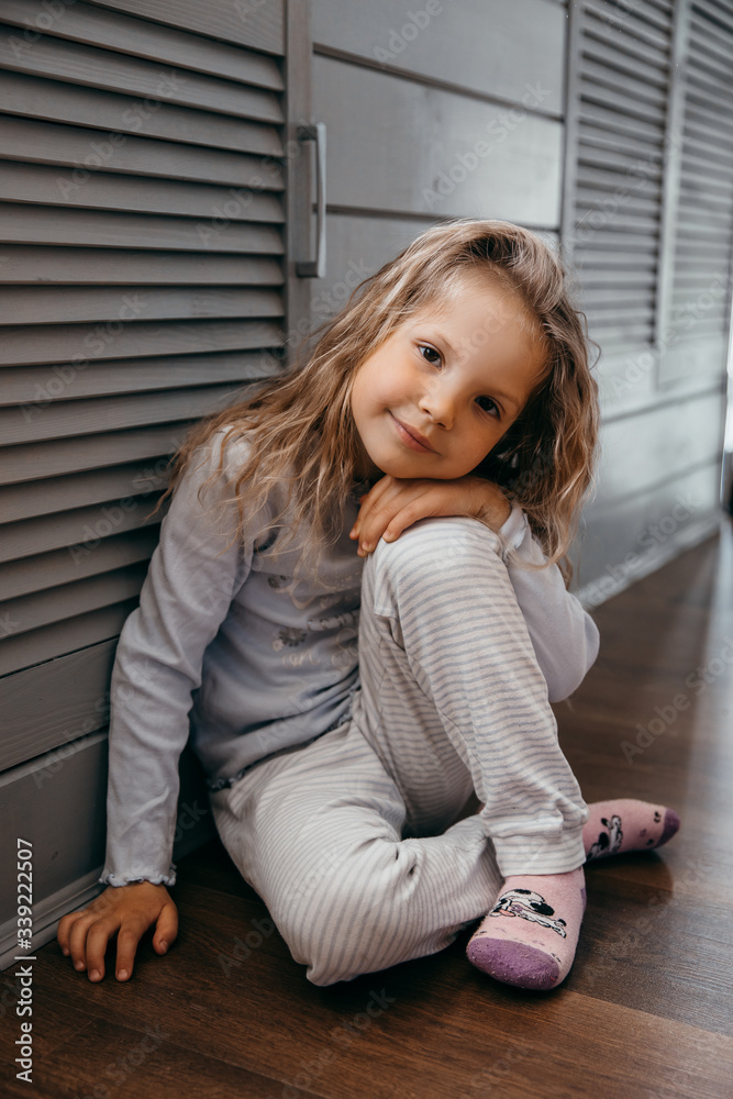 Funny little girl child missed by school at quarantine and smiling Funny little girl child missed by school at quarantine and smiling
