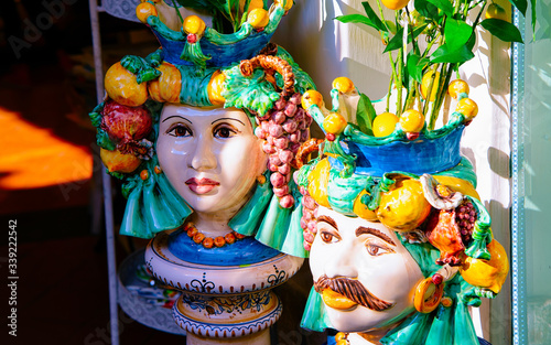 Fototapeta Naklejka Na Ścianę i Meble -  Colorful traditional ceramics vases in Positano store reflex