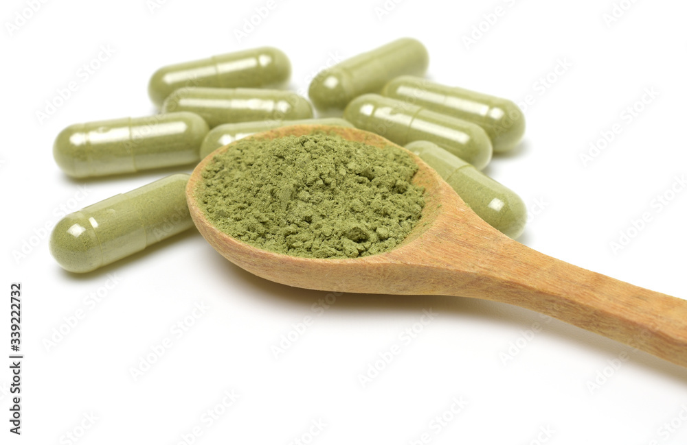 Close up,Andrographis Paniculata powder and capsules (Herbal capsules) isolated on a white background,copy space. Close up,Andrographis Paniculata powder and capsules (Herbal capsules) isolated on a white background,copy space.
