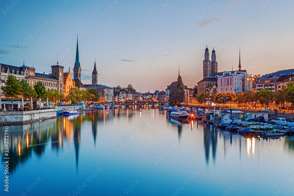 Scenic view of historic Zurich city center with famous Fraumunster and Grossmunster Churches and river Limmat at Lake Zurich, Zurich, Switzerland
