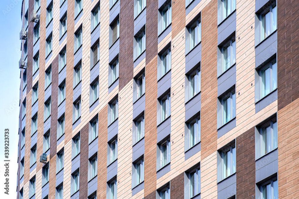 New facade of a modern residential complex. The urban background. Modern city. Modern style. Home facade. Family house. New facade of a modern residential complex. The urban background. Modern city. Modern style. Home facade. Family house.