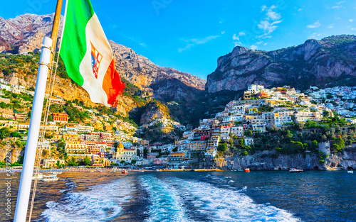Italian flag with Positano town in Tyrrhenian sea reflex