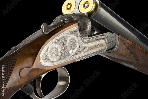 hunting gun with a beautiful engraving on a black background