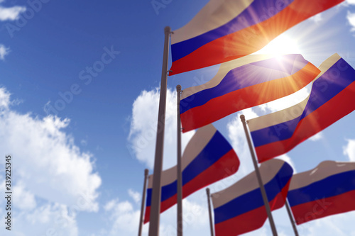 Russia flags waving in the wind against a blue sky. 3D Rendering