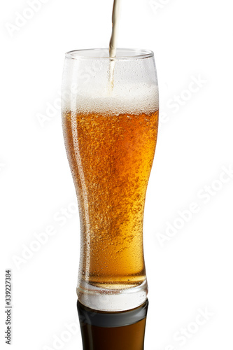 Freeze motion of pouring cold beer in glass on white background (ID: 339227384)