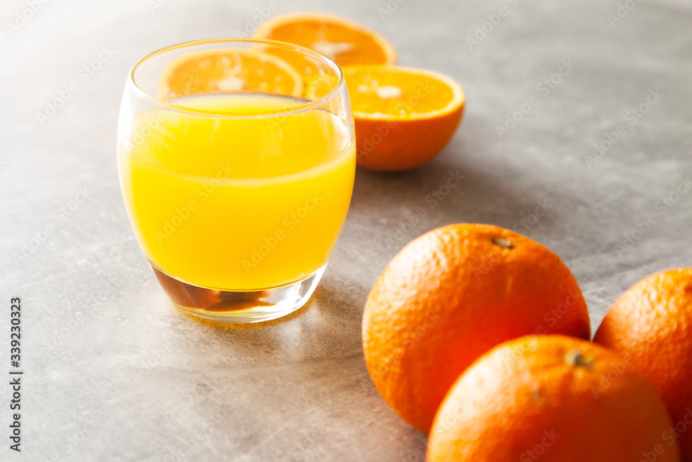 Obraz na plátně Fresh orange juice on the table and citrus fruits