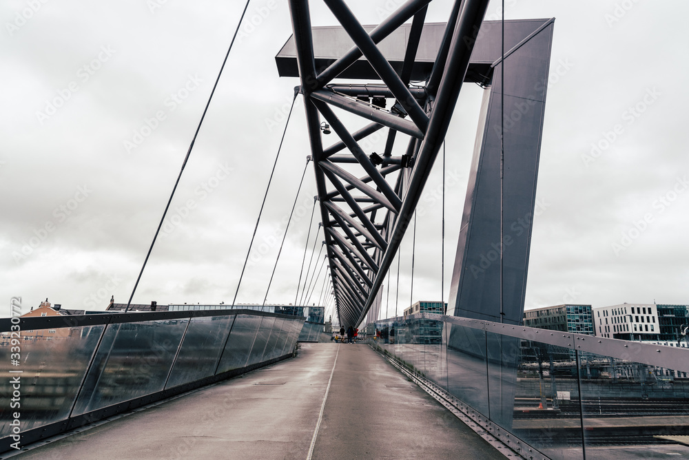 Obraz premium Akrobaten pedestrian bridge over railroad in Oslo. Cloudy day of summer