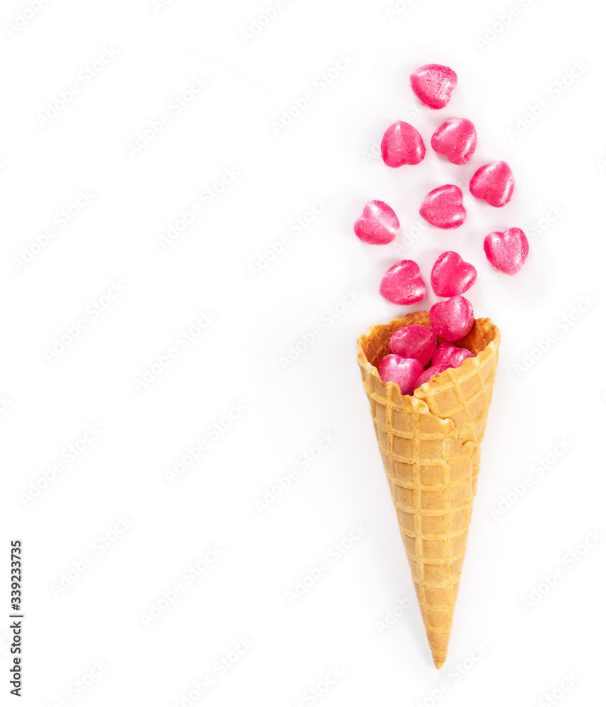 Heart shaped sweets in a waffle cone isolated on white