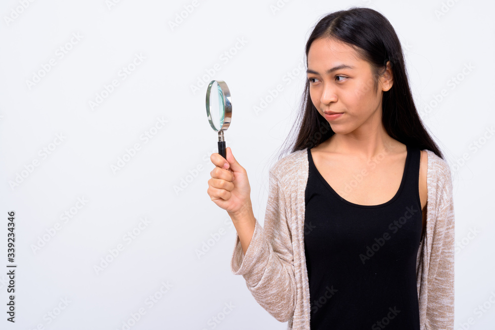 Portrait of young beautiful Asian woman with magnifying glass Portrait of young beautiful Asian woman with magnifying glass