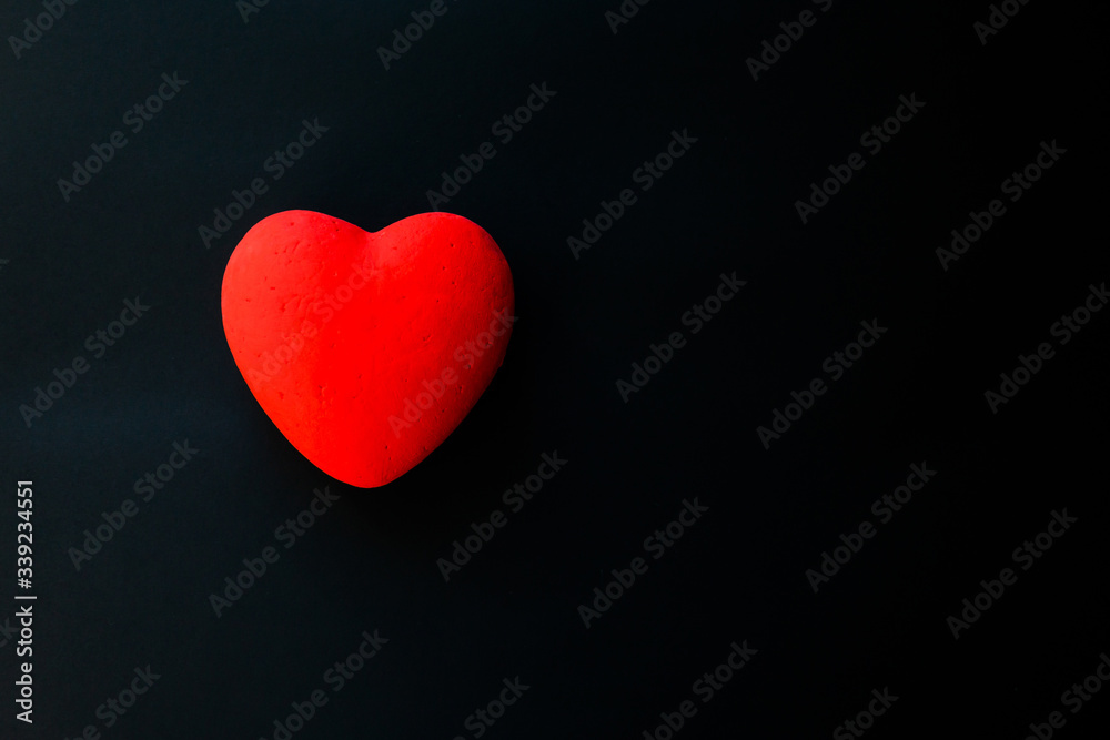 Red heart, on the black velvet background Red heart, on the black velvet background
