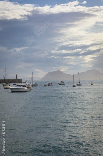 Motor boats in the harbor. Sea coast. Sea off the coast of Spain. Yachts in the water area. Landscape with boats and yachts. Water transport. Calm off the coast of the Spanish city. Boats on the water