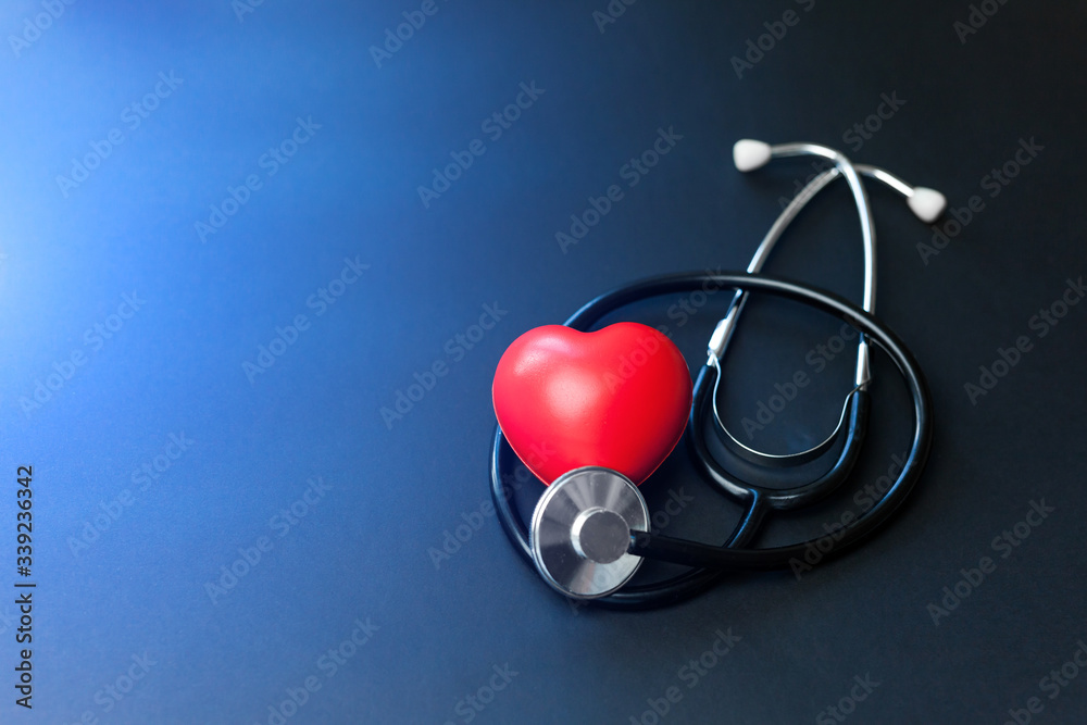 Red heart and stethoscope on blue paper. Flat lay essential items for doctor using treat and care patient in hospital. Red heart and stethoscope on blue paper. Flat lay essential items for doctor using treat and care patient in hospital.
