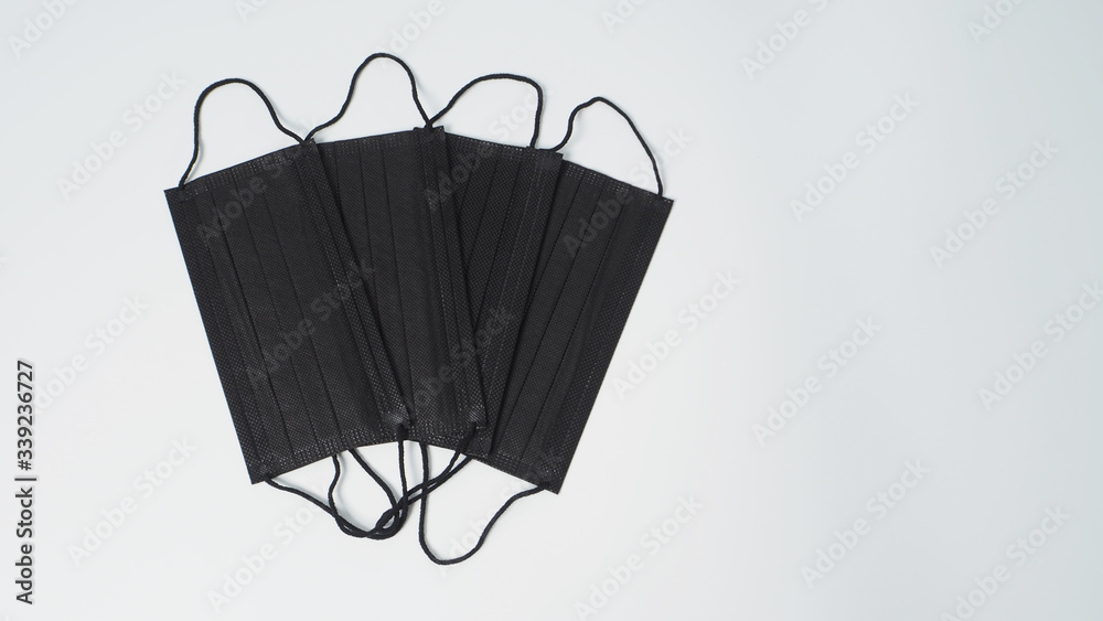 Group of black Disposable Ear- loop face mask on white background. for protect from virus infection. 