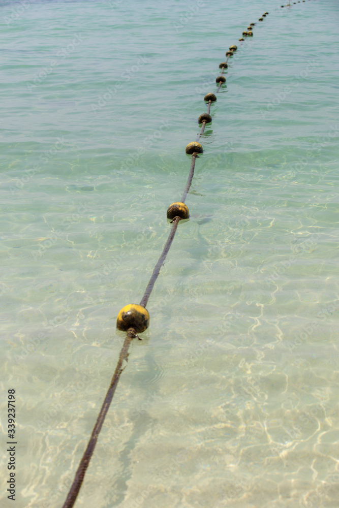 The yellow buoy are installed at the beach in the sea to identify safe areas The yellow buoy are installed at the beach in the sea to identify safe areas