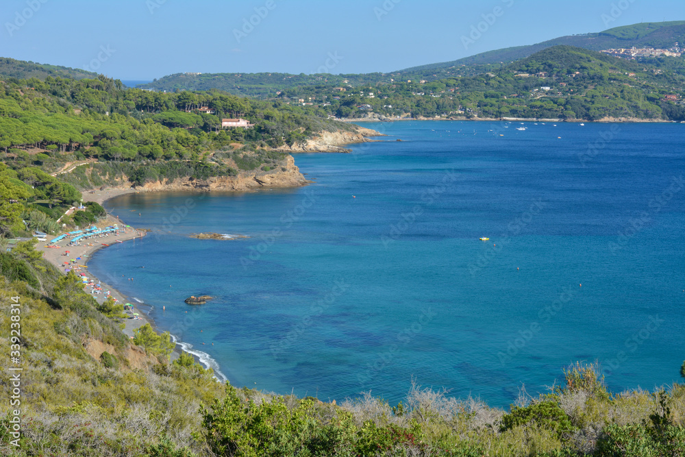 Aerial view of Norsi beach and Capoliveri hilltop town, on Elba Island. Tuscany, Italy
