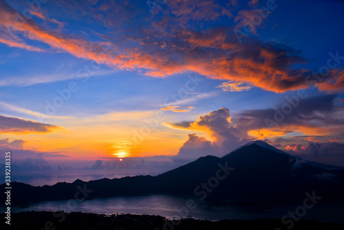 Sun is rising behind the volcano Mount Batur, Bali, Indonesia 