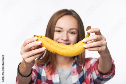 Teen girl outstretching giving you a banana
