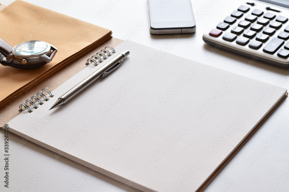 Close-up view, Free space on a notebook for writing or designing easily with book, pencil, calculator, mobile and wrist watch is elements. Close-up view, Free space on a notebook for writing or designing easily with book, pencil, calculator, mobile and wrist watch is elements.