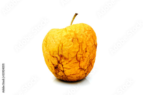 фотографія wizened wrinkled yellow apple isolated on white background
