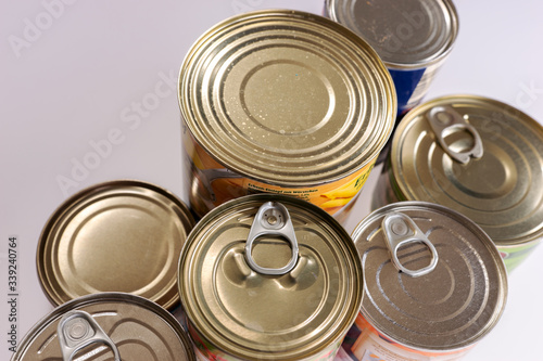 Various canned food in metal cans, top view. Canned goods non perishable food storage goods