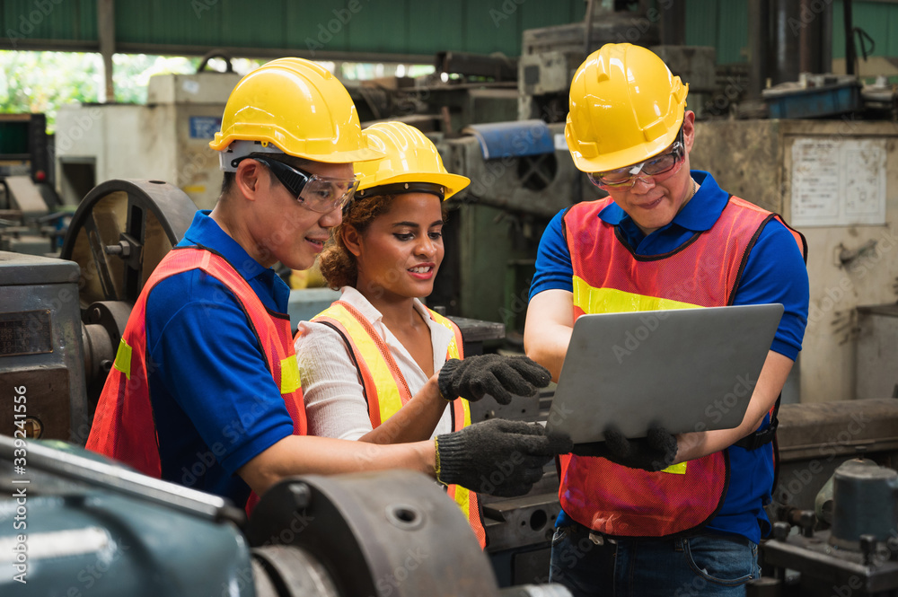 The industrial worker team is working on various projects in a large industrial factory with many equipment. The industrial worker team is working on various projects in a large industrial factory with many equipment.