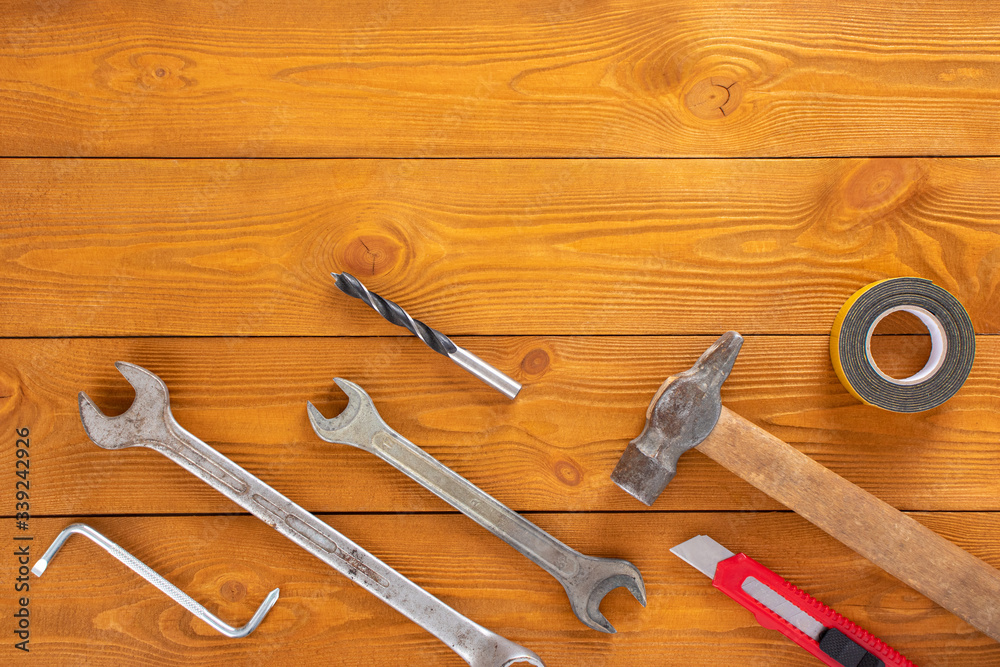 Top view layout of tools for repair on wooden background, free space for text Top view layout of tools for repair on wooden background, free space for text