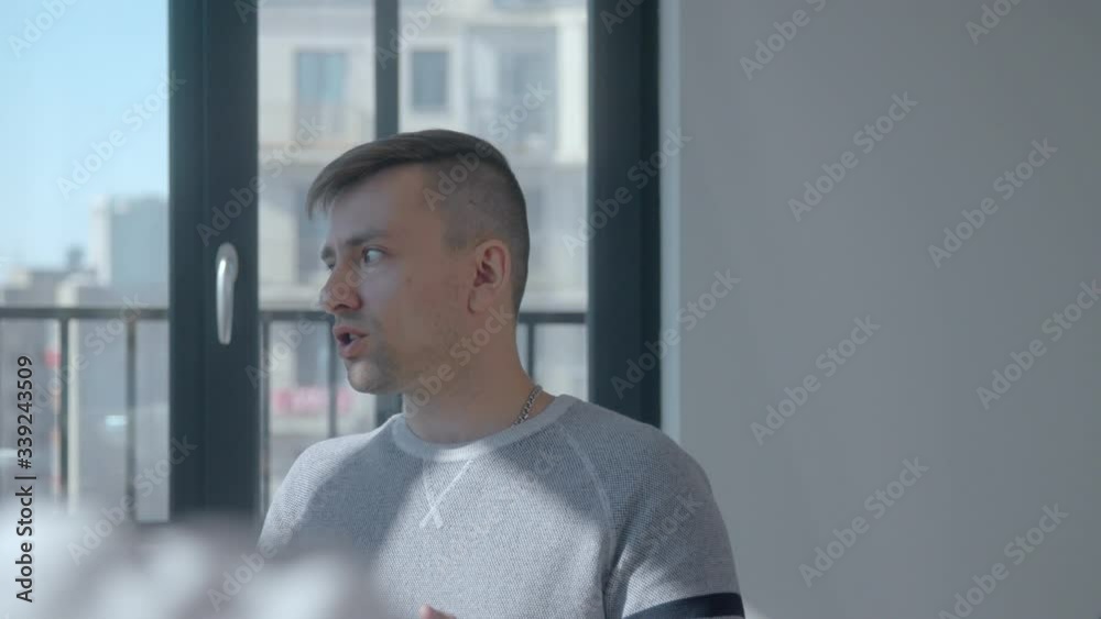 Sad pensive caucasian man shares his addiction story during a meeting of the club of anonymous gamers. Concept of uniting people solving their problem with the help of experience and hopes Sad pensive caucasian man shares his addiction story during a meeting of the club of anonymous gamers. Concept of uniting people solving their problem with the help of experience and hopes
