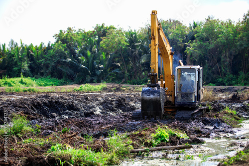 Backhoes is doing digging grooves for gardening for agriculture.