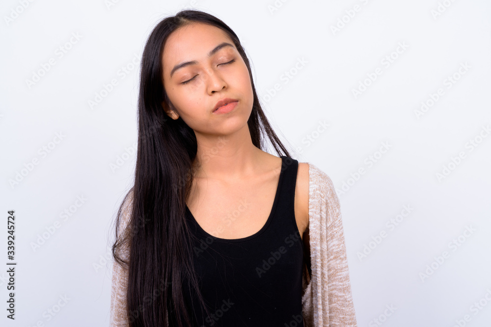 Portrait of young beautiful Asian woman with eyes closed Portrait of young beautiful Asian woman with eyes closed