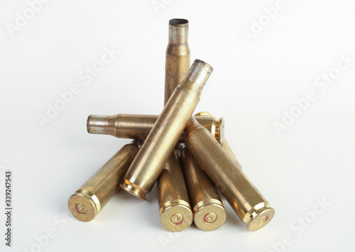 rifle bullet shell casings on white background