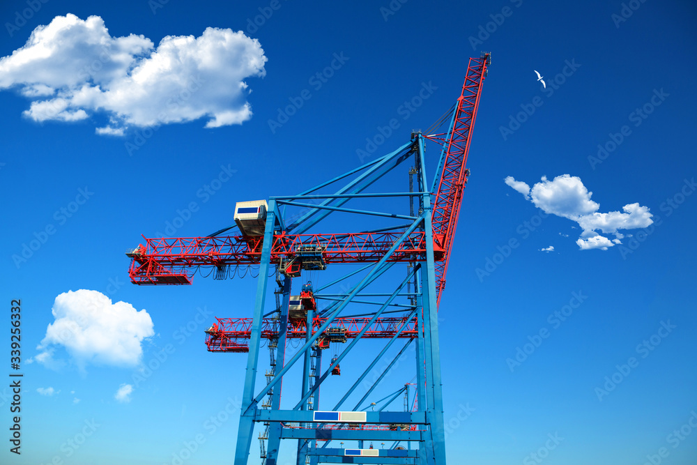 Cranes of container terminal cose up in industrial sea port. industrial port with containers