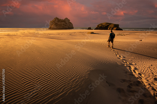  Hiker in sand desert  Whararirki beach  New Zealand 