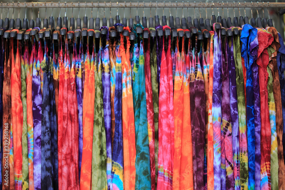 Multicolored fabric hanging on the clothesline for sale to customers