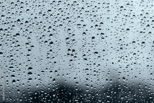 Window with raindrops in a stormy day