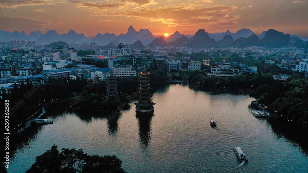 sunset over the lake in Riyue Shuangta Cultural park, Guilin, China