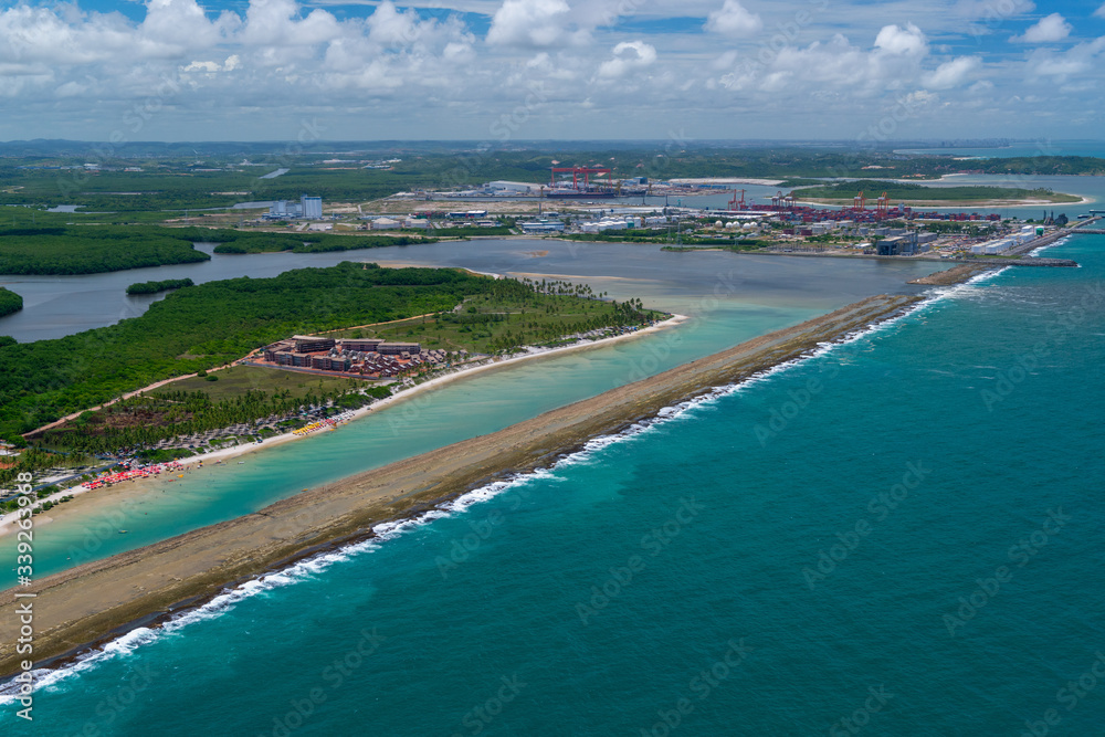 Luxury resorts in Muro Alto beach, Porto de Galinhas, near Recife, Pernambuco, Brazil on March 1, 2014. In the background, the port of Suape. Aerial view.
