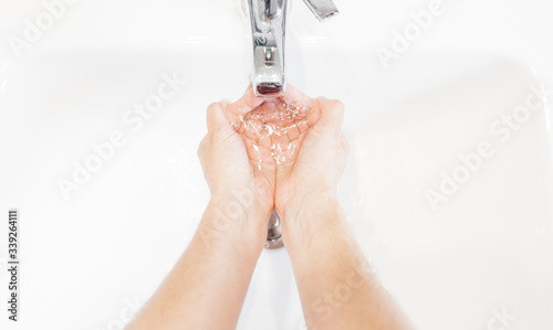 Man washing his hands hygienically with soap