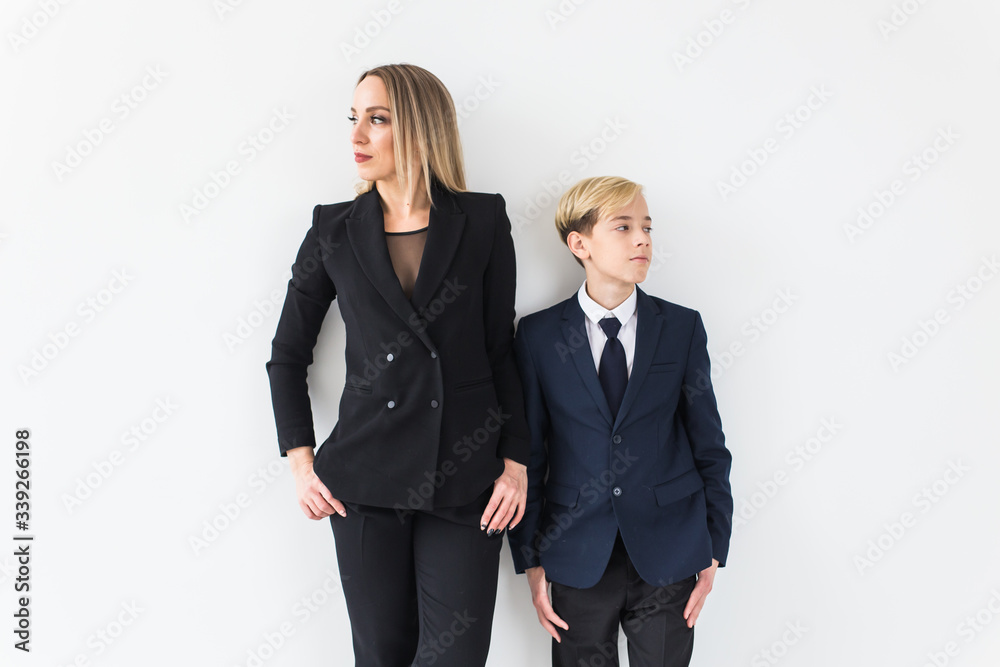 Teenager and single parent - Young mother and son standing together on white background. Teenager and single parent - Young mother and son standing together on white background.