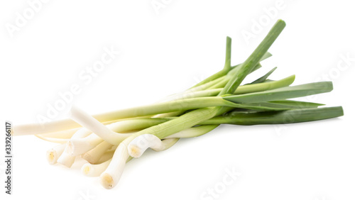 Young green garlic closeup on a white. Isolated