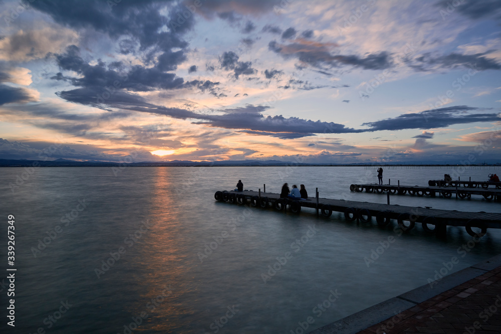 Jetty on a lake a stormy day, sunset